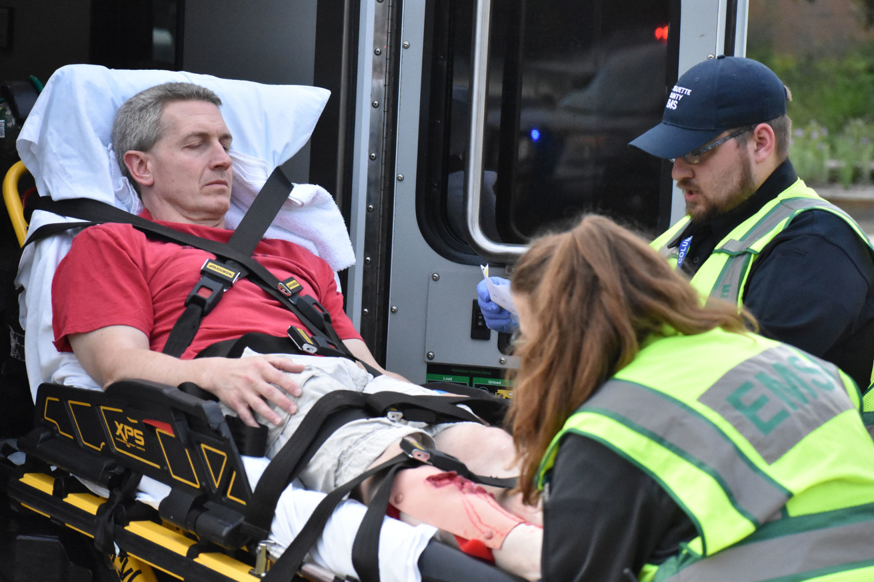 First responders lift man into ambulance